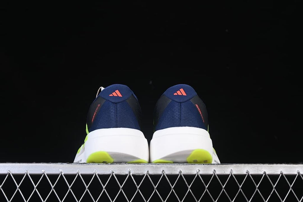 Rear view of the pair showing heel details and lime outsole sections.