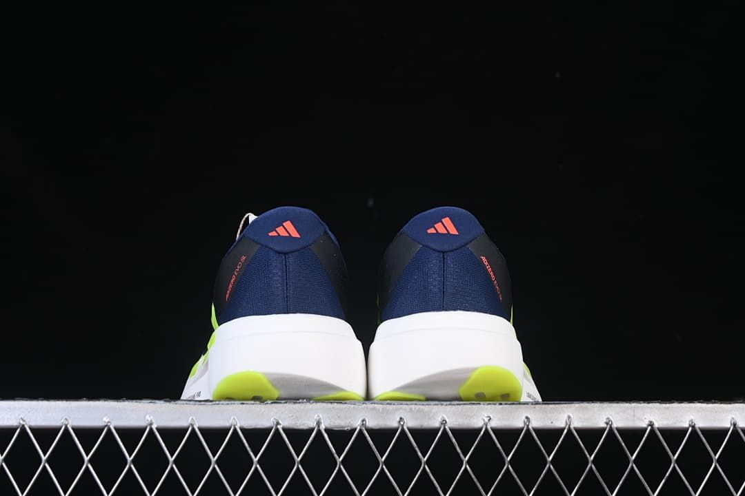 Rear view of the pair showing heel details and lime outsole sections.