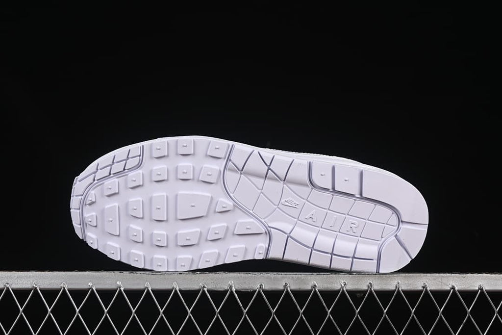 Underside view of the white sneaker outsole