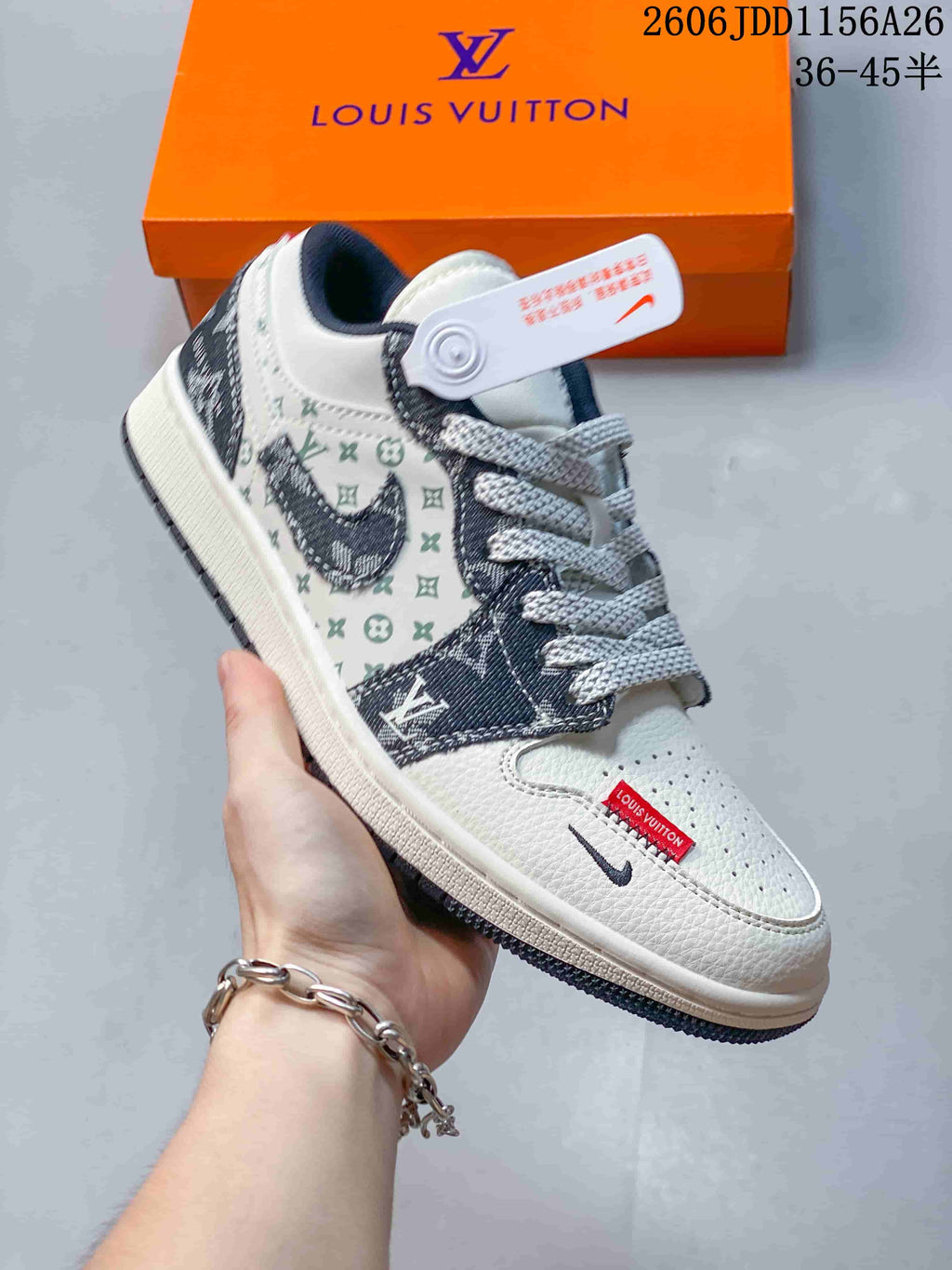 Side view of a white low-top sneaker with dark patterned overlays and contrast laces.