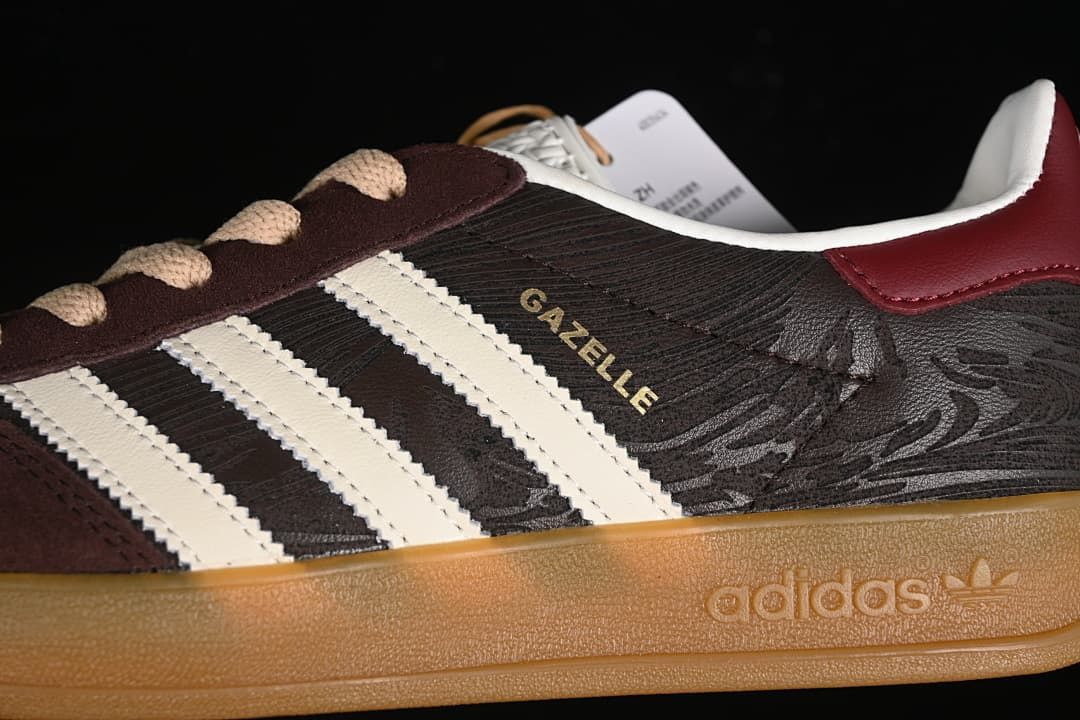 Close-up of the sneaker side showing off-white stripes, Gazelle lettering, and gum-colored sole.