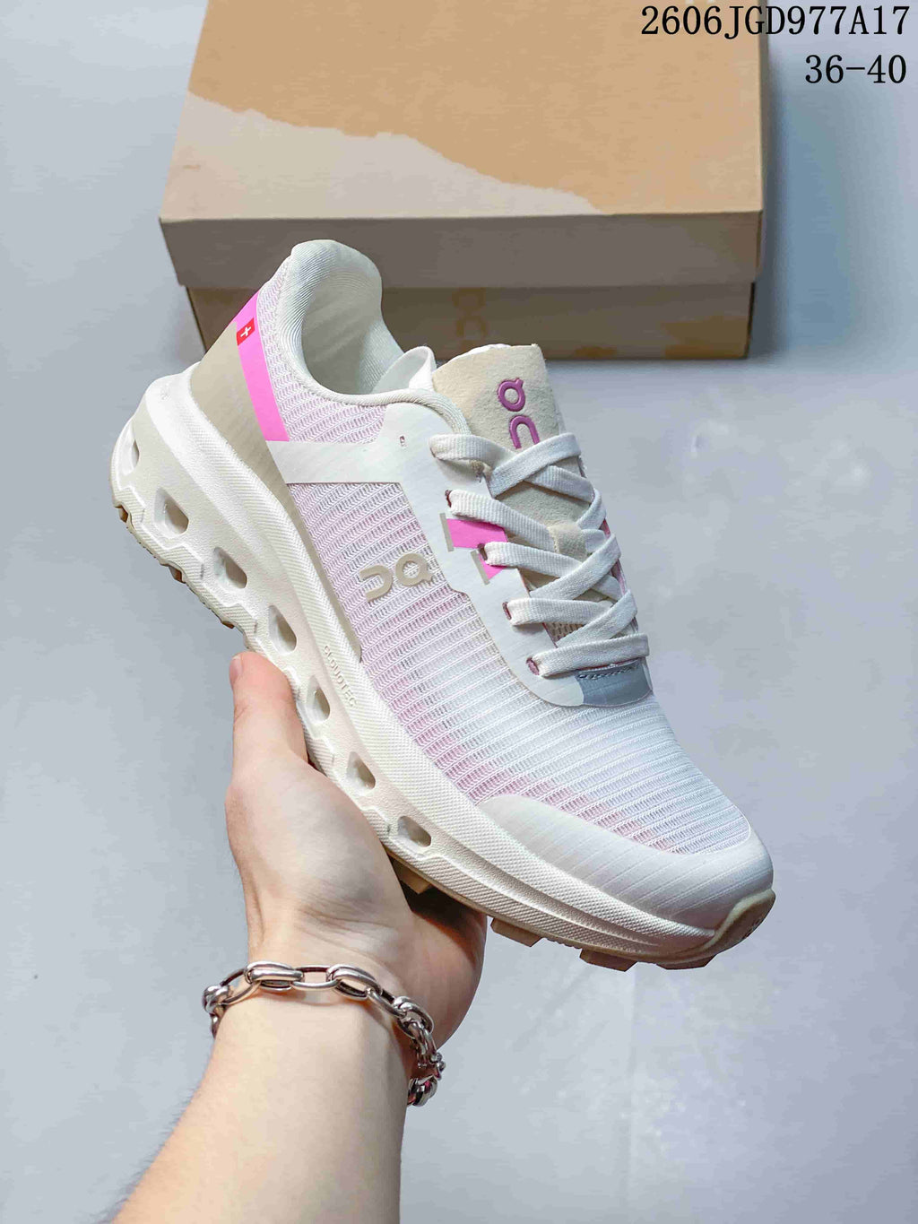 Angled side view showing the upper, pink accents and thick sole.