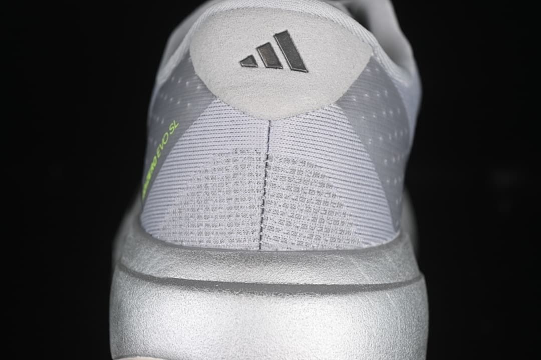 Rear view of the shoe with adidas heel branding and lime detail.