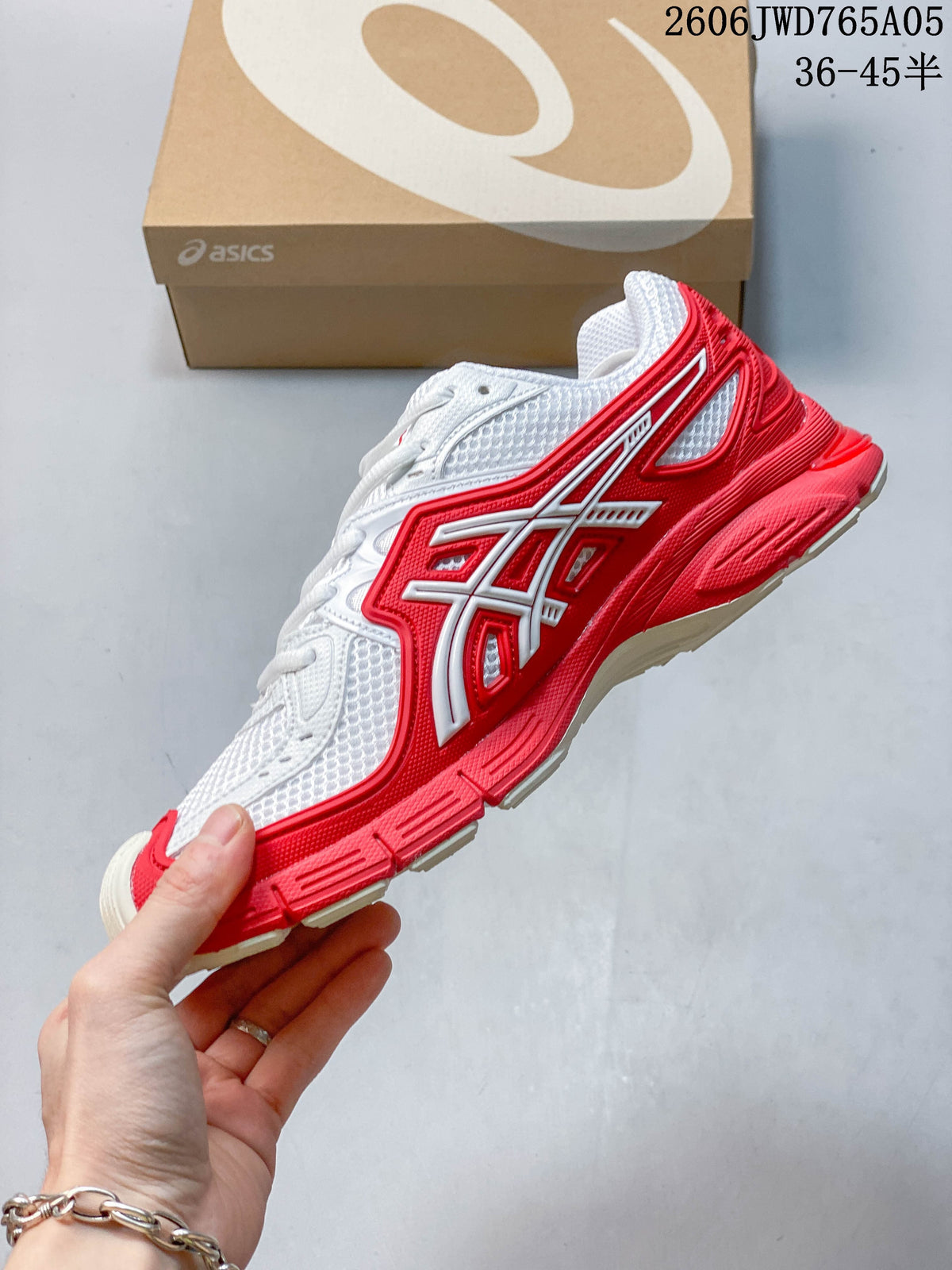 Side view showing the red overlays and white upper of the ASICS Gel-TRUCK sneaker