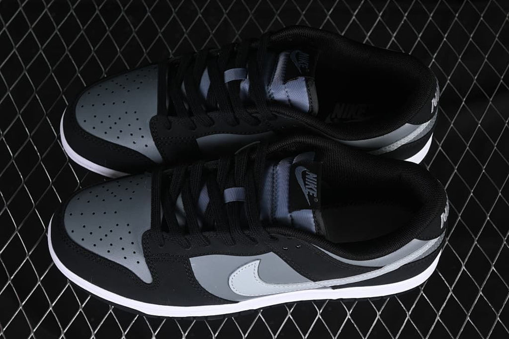 Pair of black, grey, and white low-top sneakers viewed from above