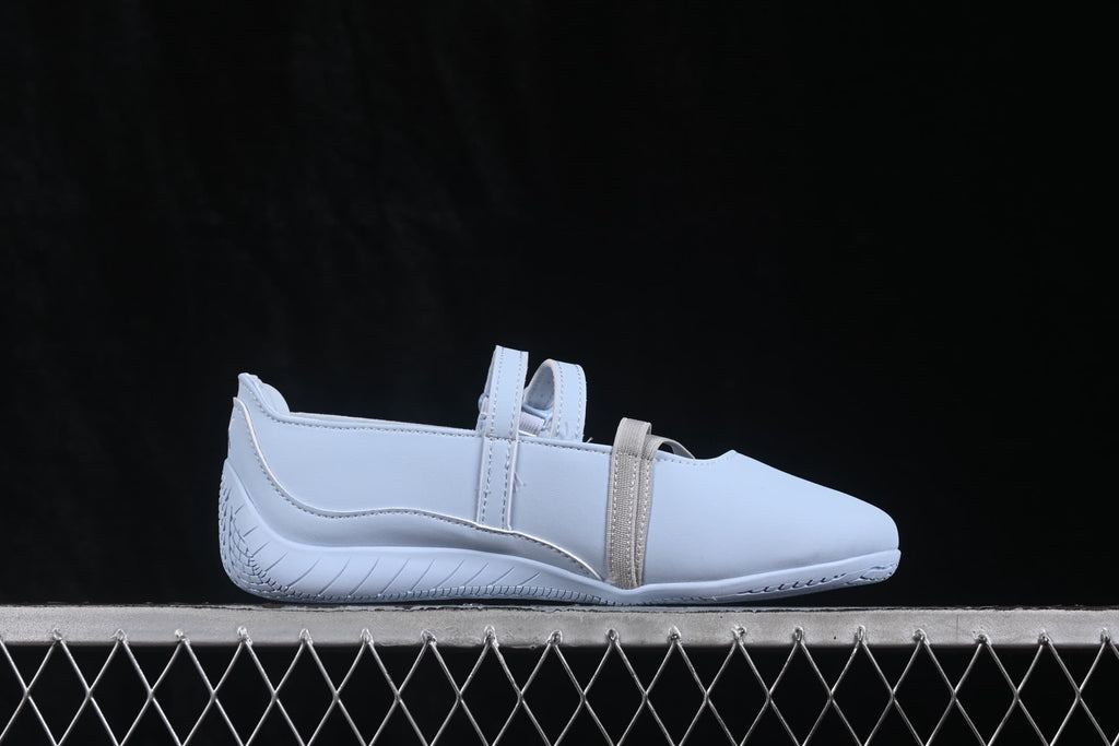 Side profile showing the low-profile silhouette, elastic straps and curved outsole.