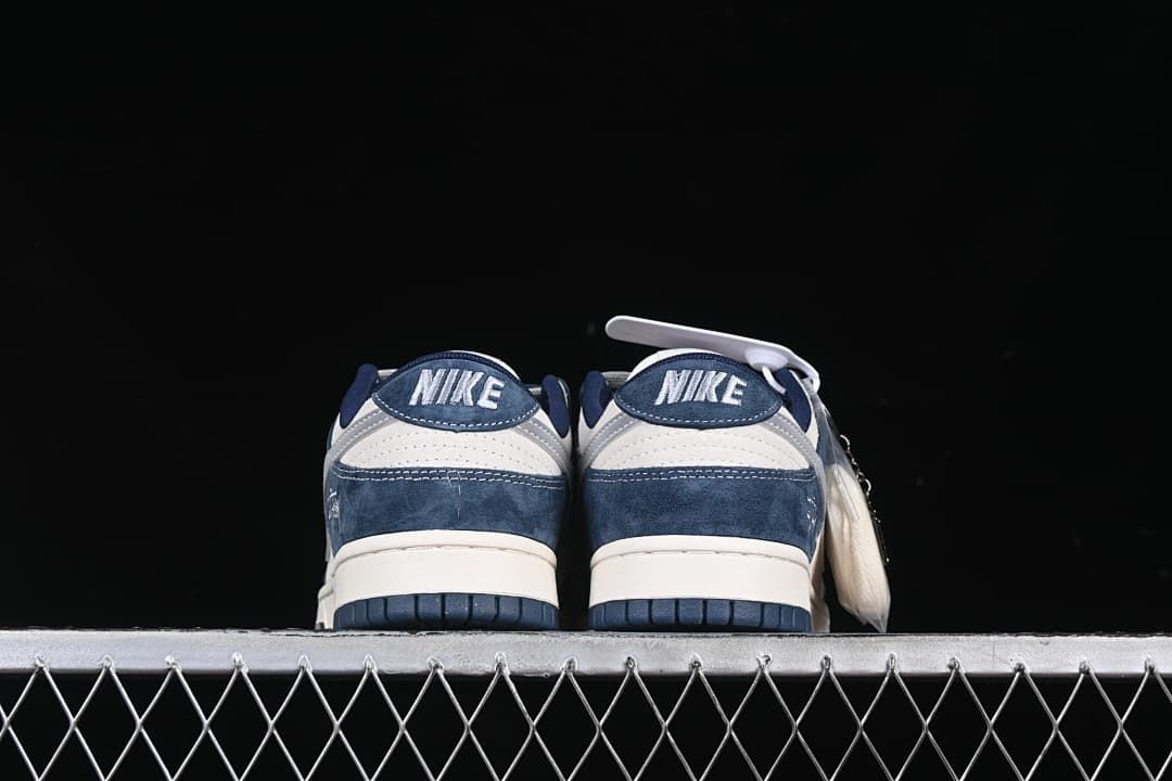 Rear view of both sneakers showing heel panels and soles