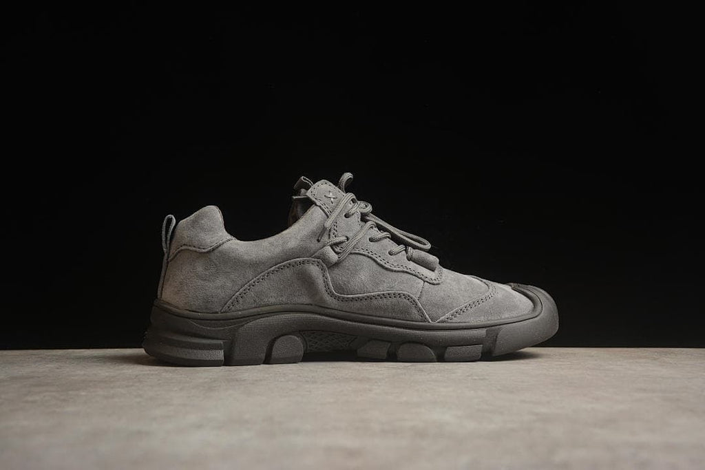 Side profile of a gray CAT low-cut lace-up sneaker.