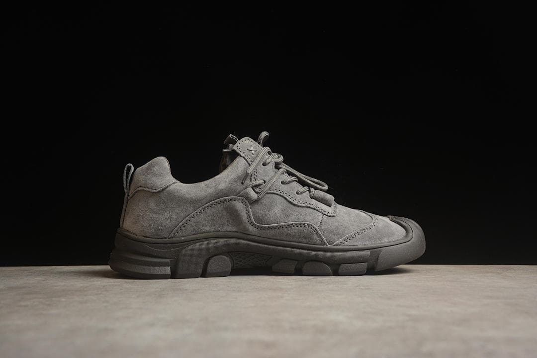 Side profile of a gray CAT low-cut lace-up sneaker.