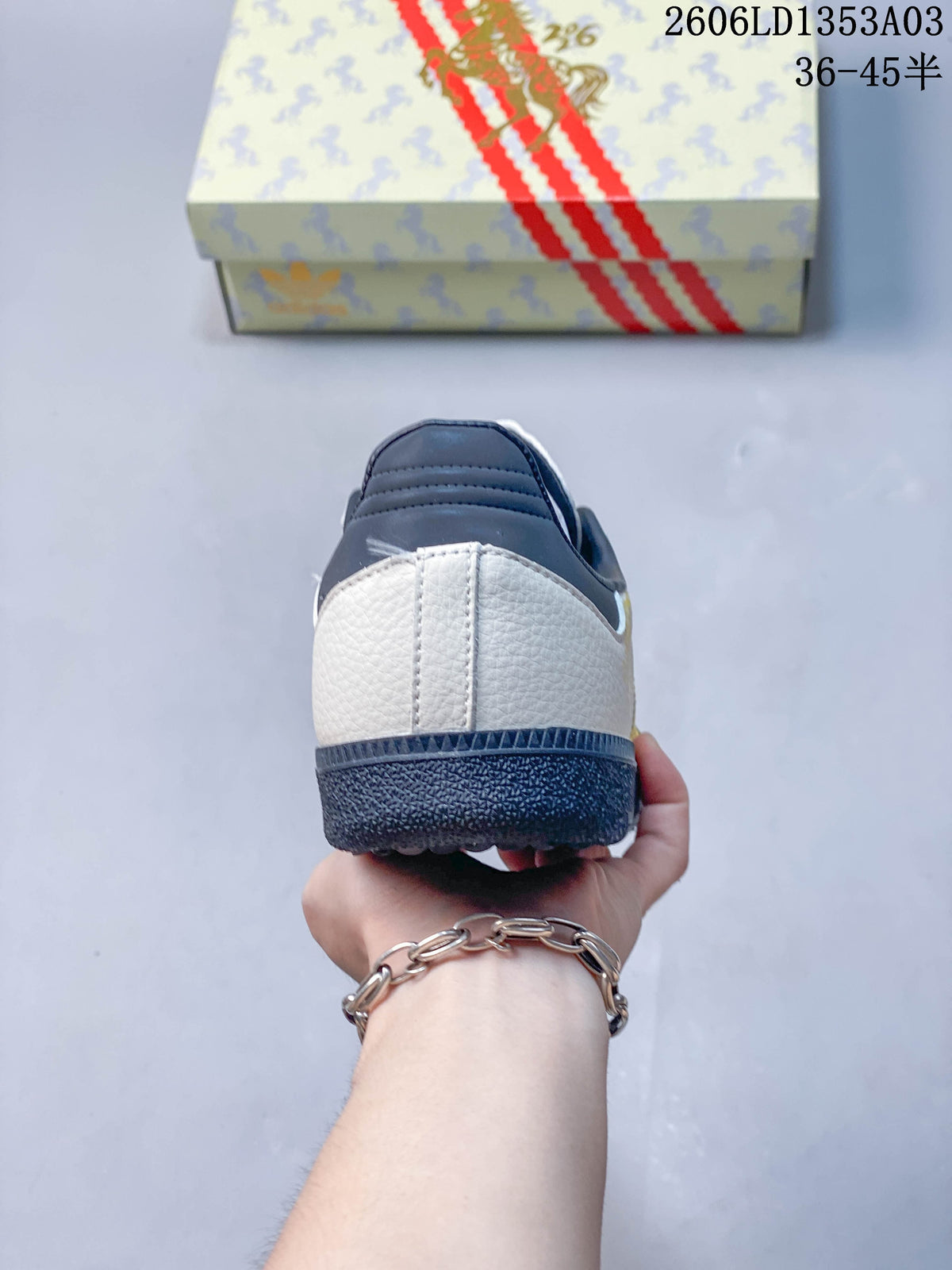 Rear view showing the white heel panel and navy collar and outsole.