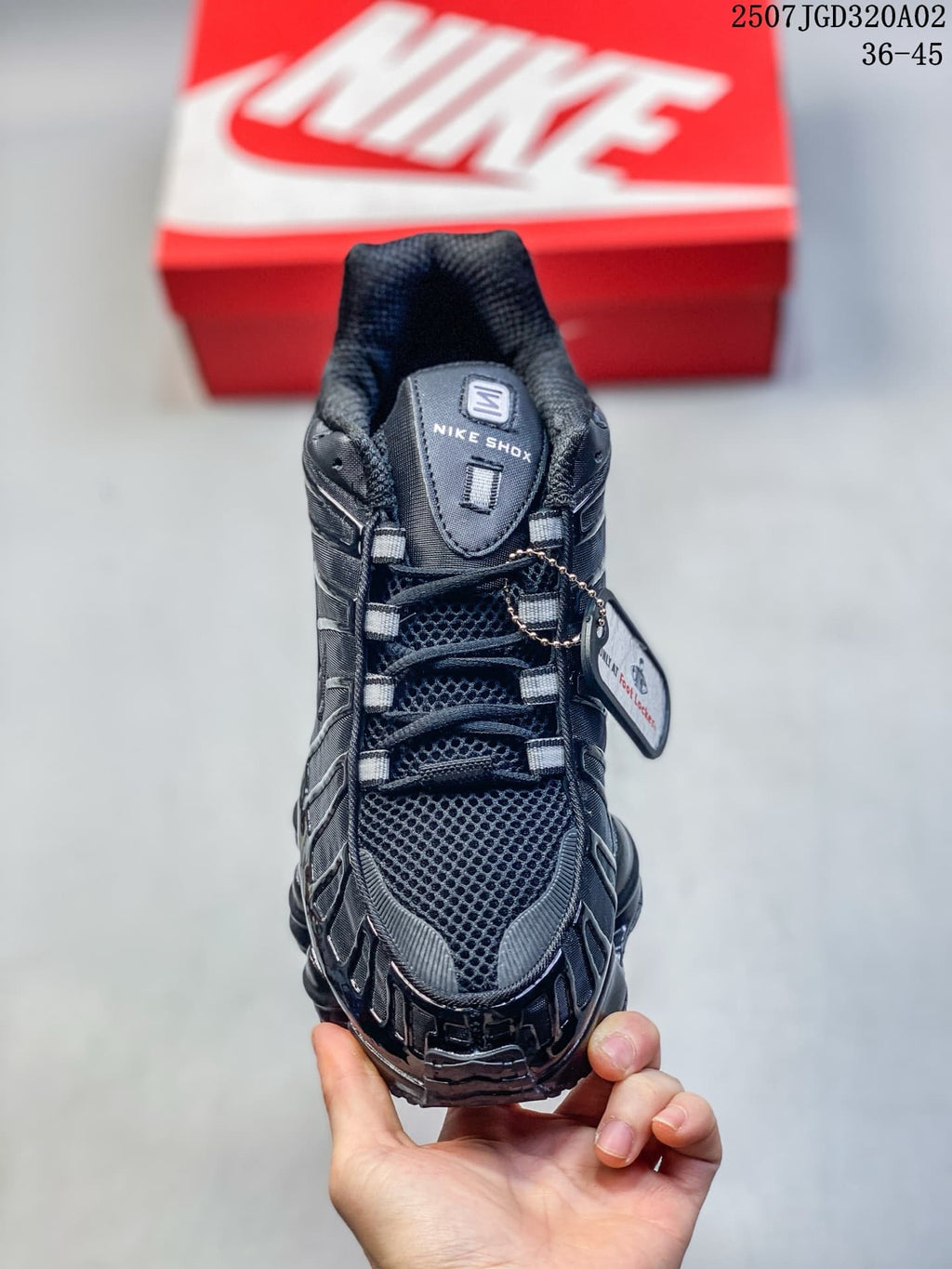 Front view of a black lace-up sneaker with mesh-look panels