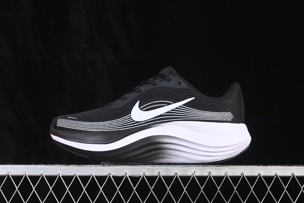 Side view of a black Nike Journey Run shoe with white side detailing and a thick black-and-white sole