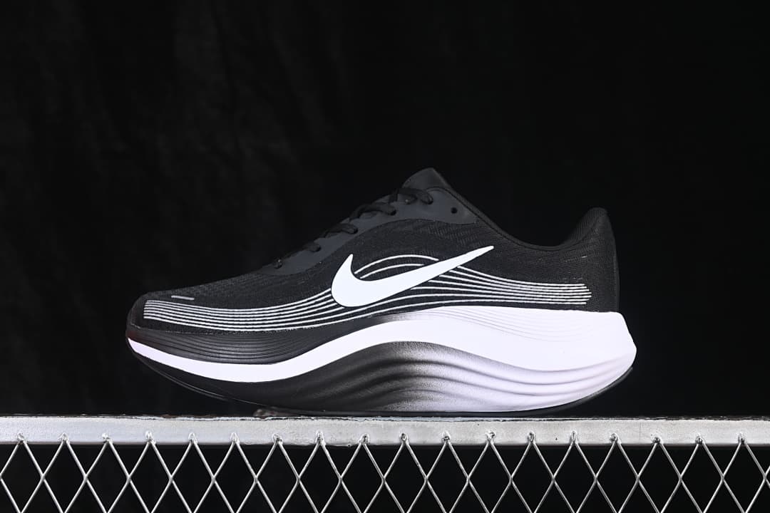Side view of a black Nike Journey Run shoe with white side detailing and a thick black-and-white sole