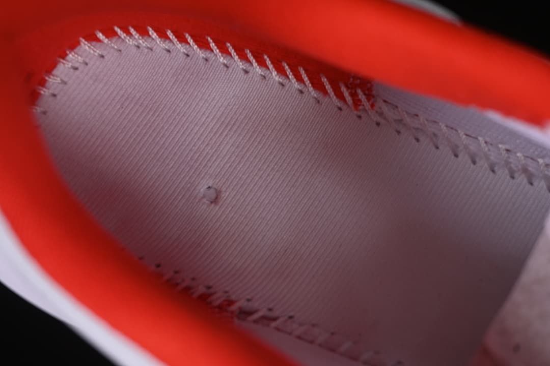 Close-up of stitching and red lining inside the shoe