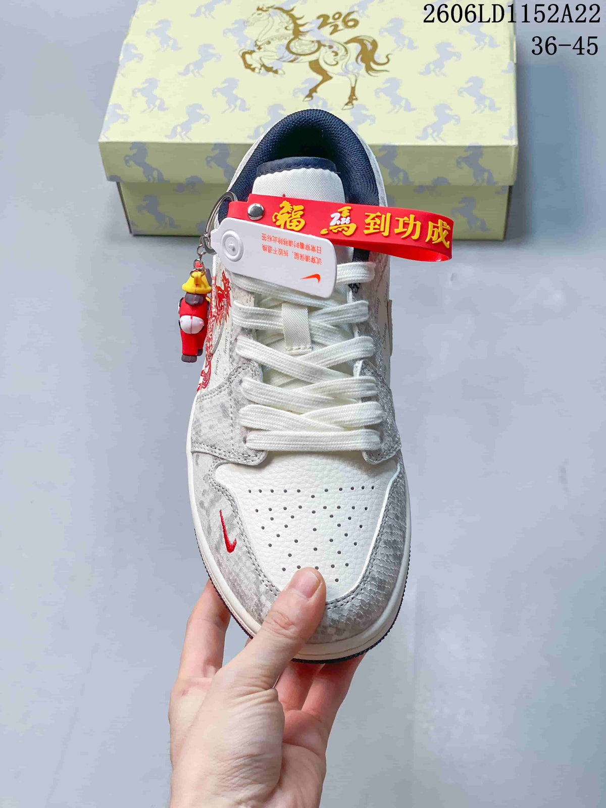 Top view highlighting the perforated toe, white laces, and red accents on a Jordan Air Jordan 1 Low sneaker.