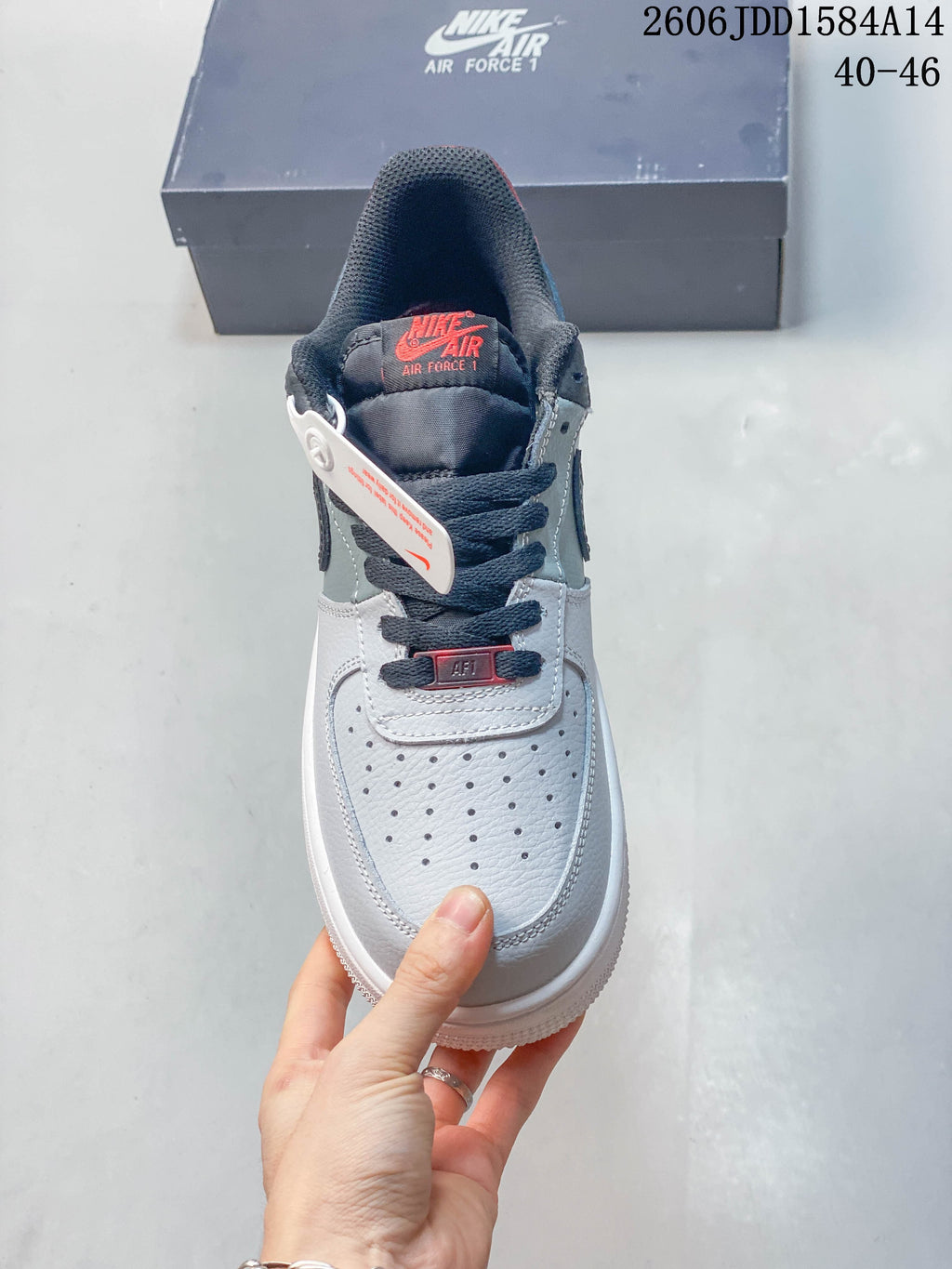 Front view showing the perforated toe, dark laces, and red details