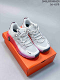 Pair of white Nike Free Metcon 7 training shoes with coral and purple accents, shown on an orange shoebox.
