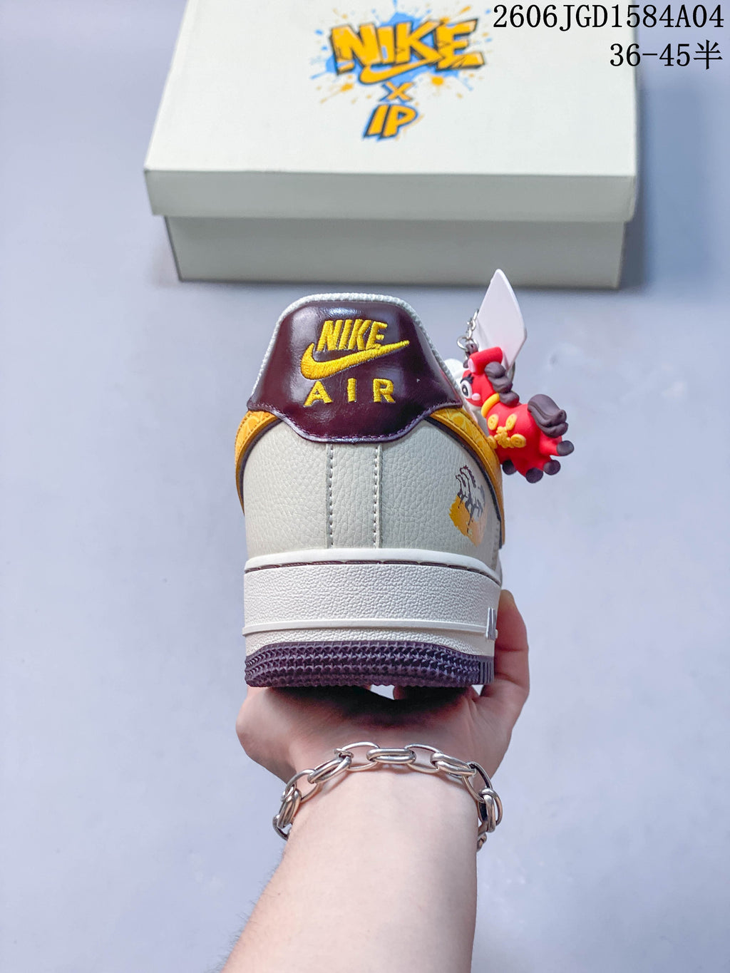 Rear view showing burgundy heel tabs and ivory uppers