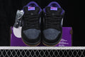 Pair of Nike SB Dunk Low sneakers shown from the front in black, navy, purple, and gum tones.