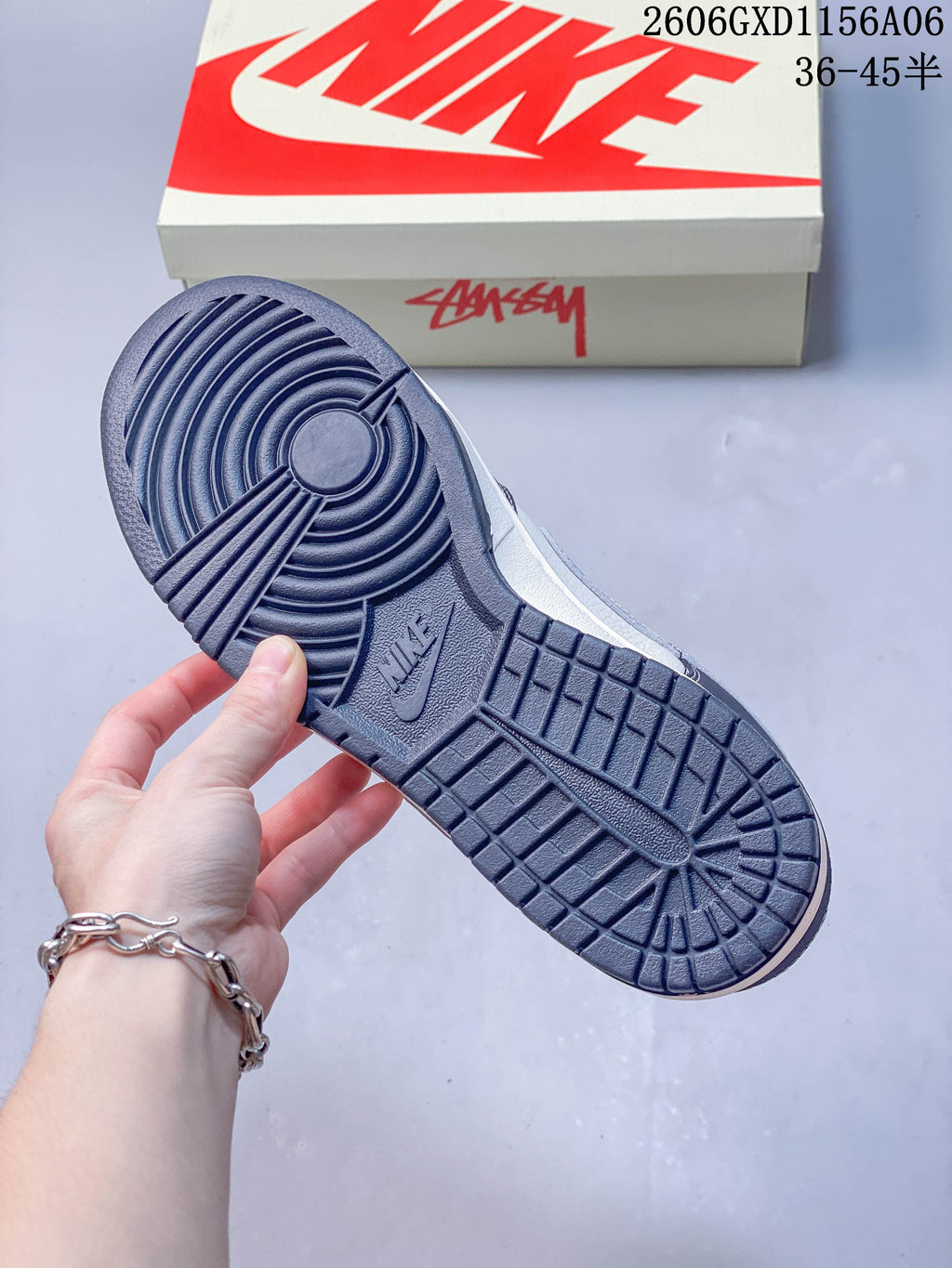 Close-up of the dark navy patterned outsole on the low-top sneaker.