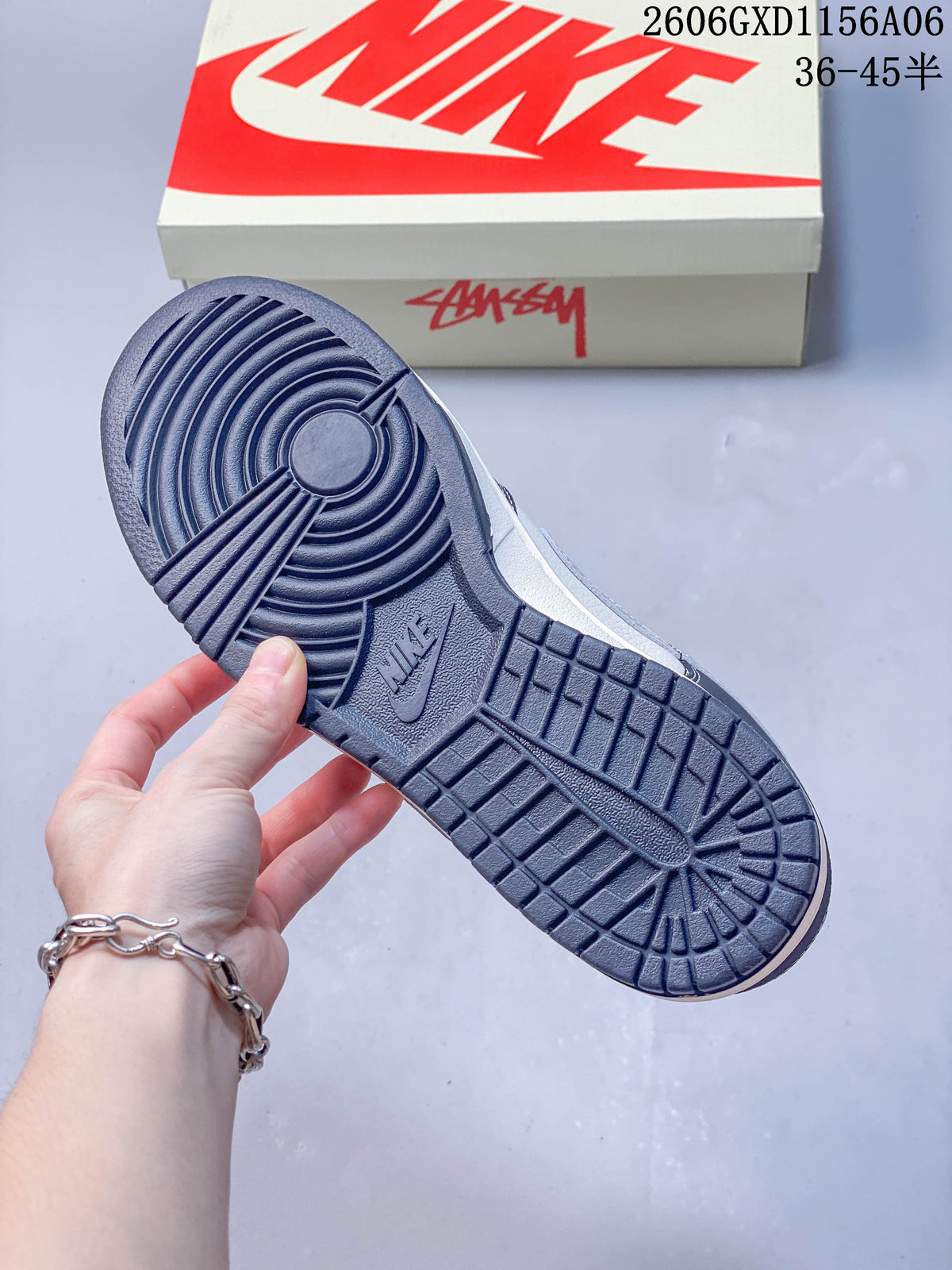 Close-up of the dark navy patterned outsole on the low-top sneaker.