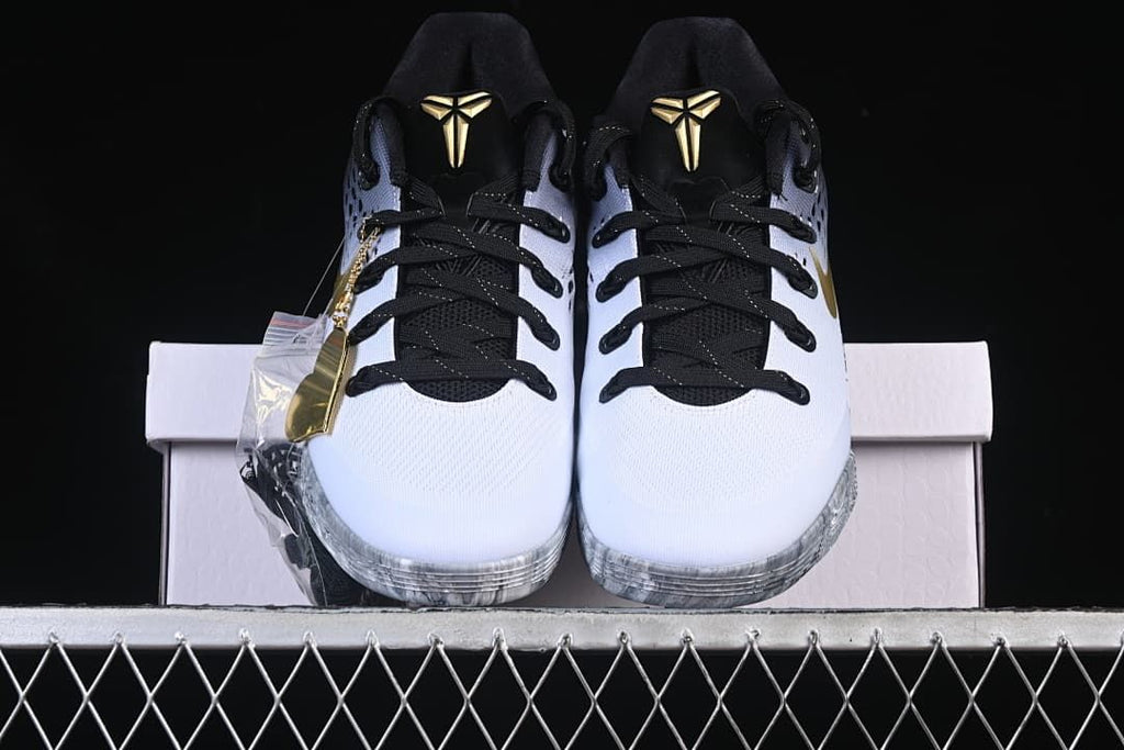 Front view of both shoes showing gold tongue logos