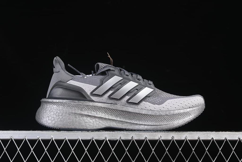 Side profile of the grey shoe with three-stripe detail
