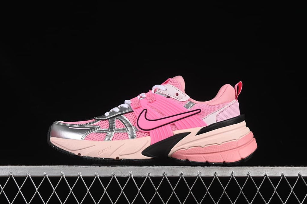 Side view of a pink Nike V2K Run sneaker with silver-look overlays and a sculpted sole