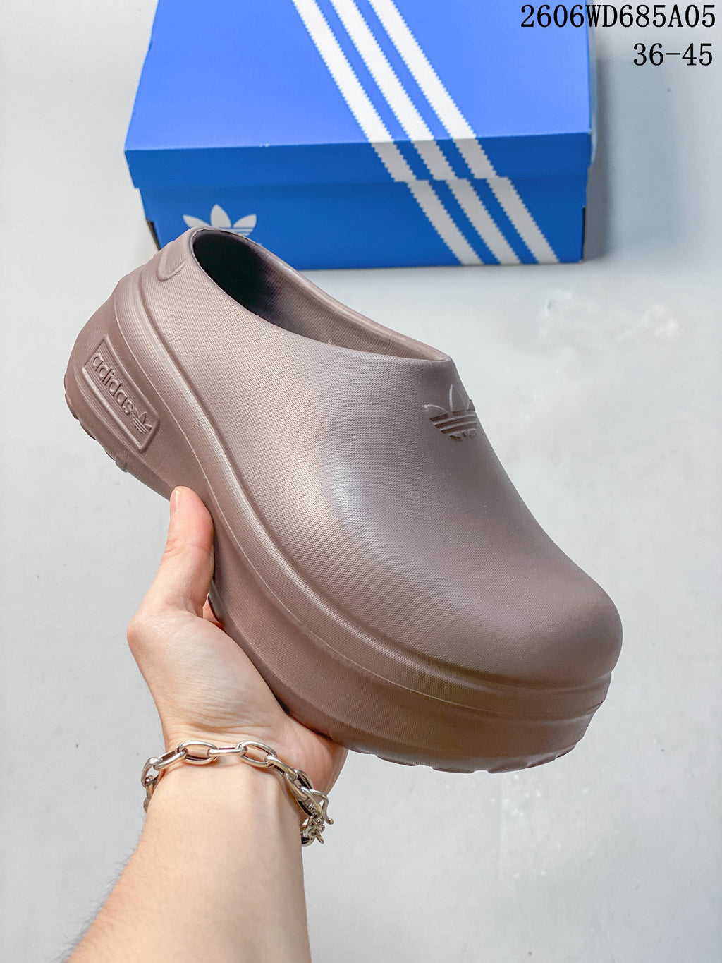 Adidas mule clogs shown from the side in several colors