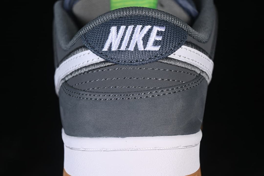Rear view showing the Nike heel tab, gray panels, white midsole, and gum outsole.