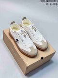 Pair of white and beige Descente Chron Pacer CVS low-top sneakers on a box
