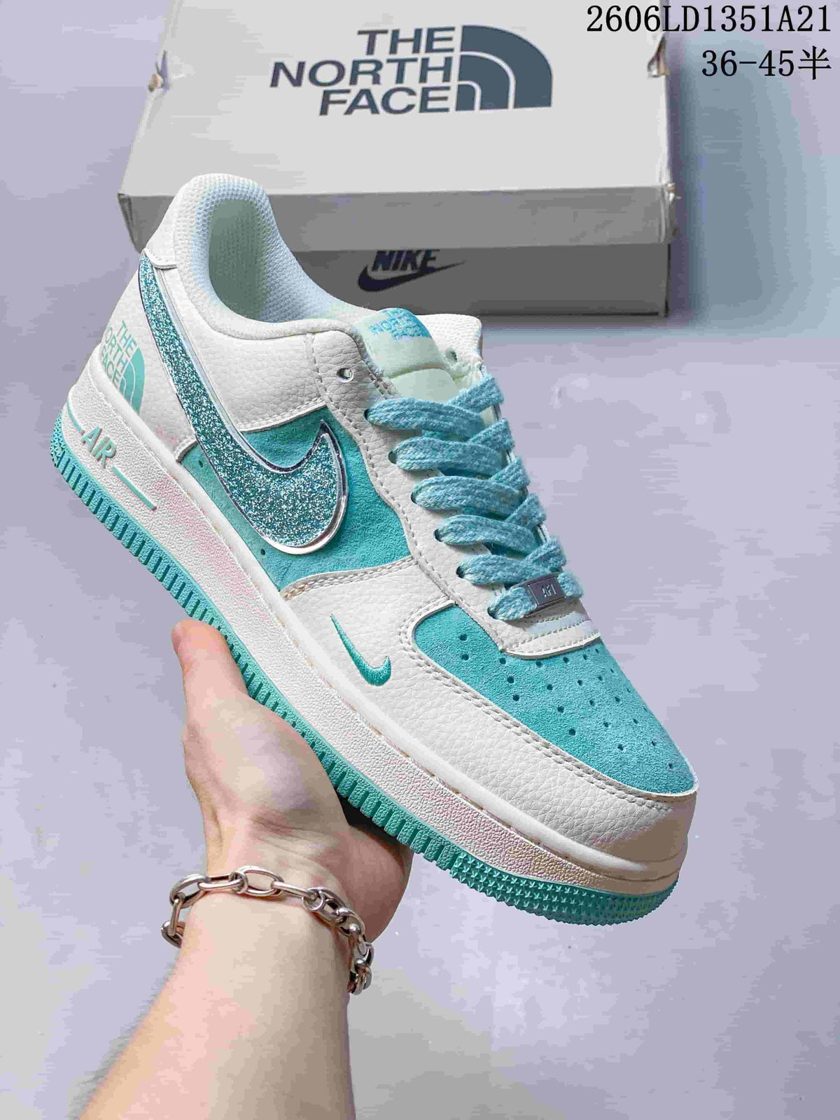 White low-top sneaker with teal glitter Swoosh and turquoise accents
