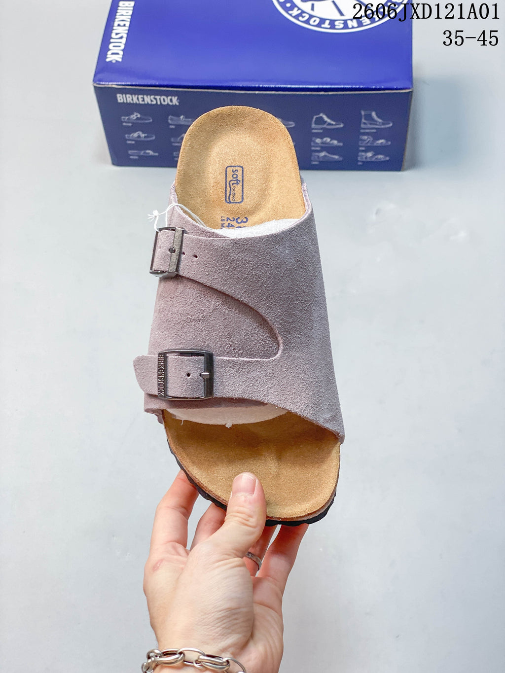Top view of a mauve two-strap sandal showing its footbed and buckles