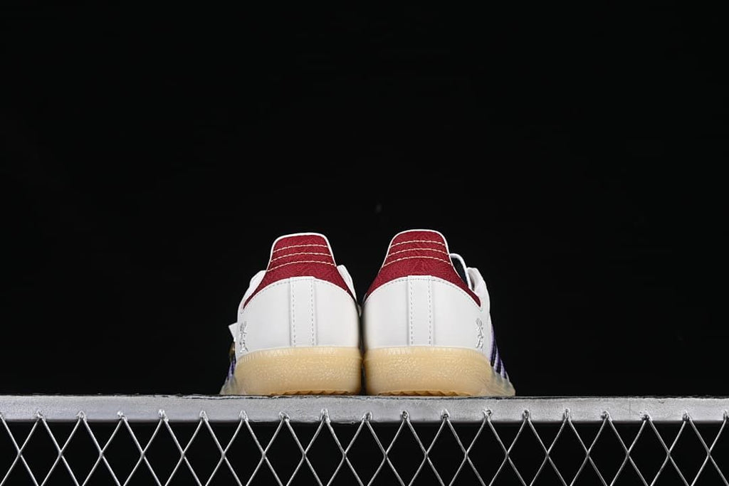 Rear view of both sneakers showing red heel panels and gum-colored soles