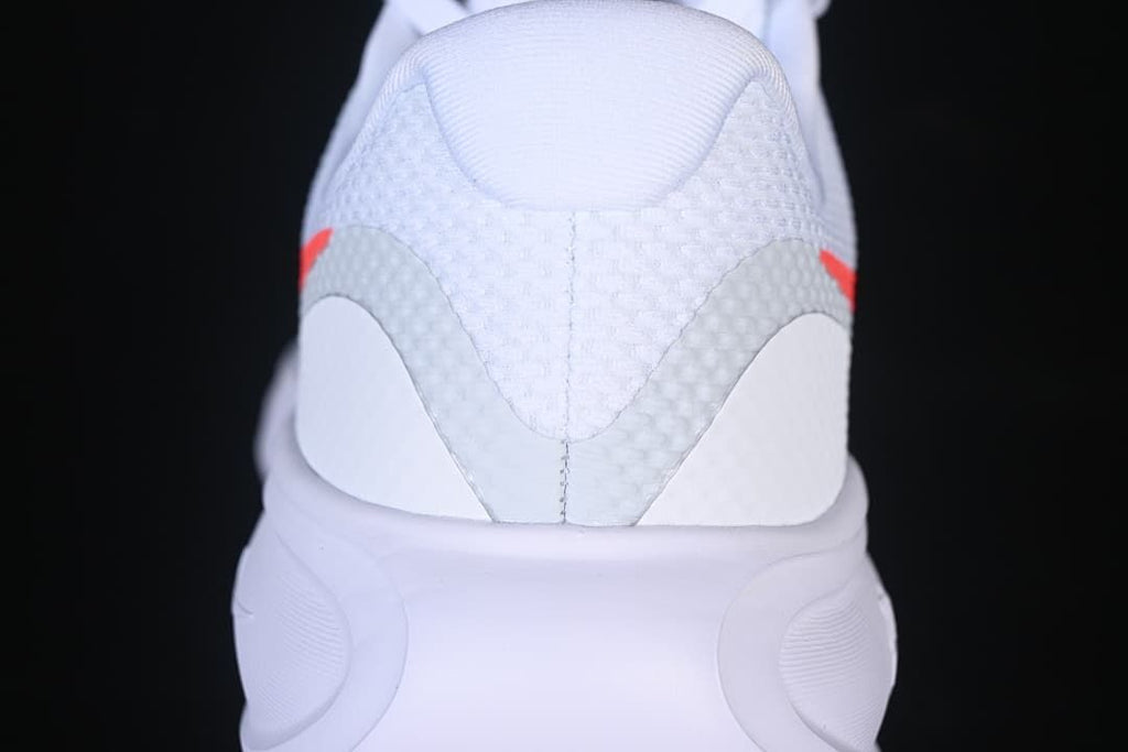 Rear view of the white shoe showing the heel and midsole