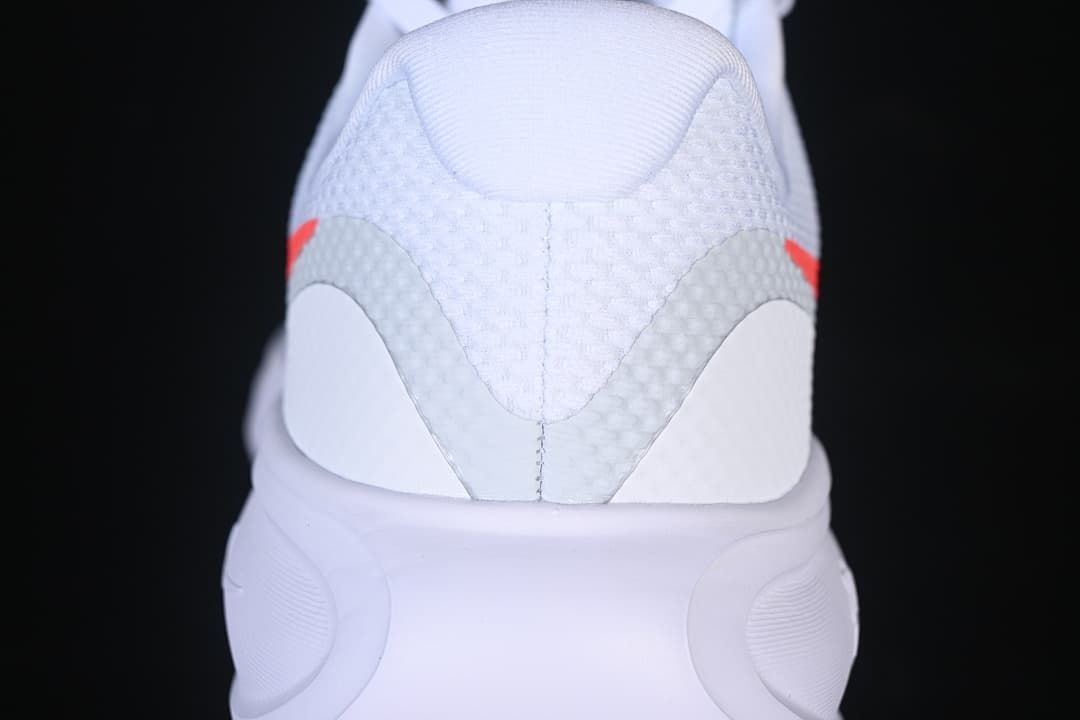 Rear view of the white shoe showing the heel and midsole