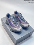 Pair of KAILAS FUGA DU 2 low-cut trail running shoes in purple, gray, and taupe, shown on a shoe box.