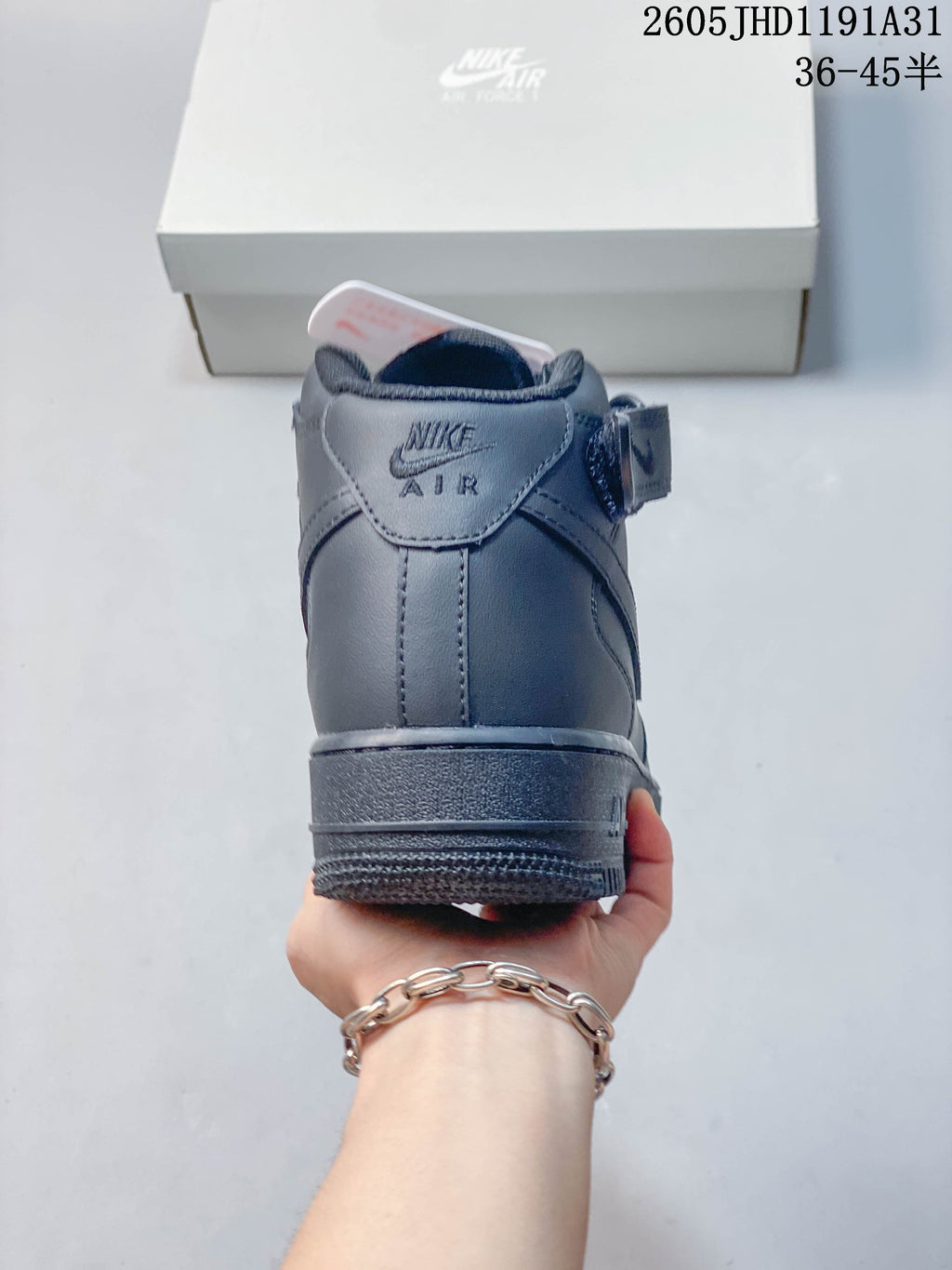 Rear view of a gray high-top sneaker with Air branding at the heel