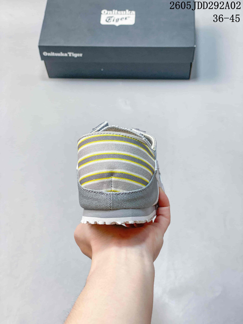 Rear view showing the striped heel panel with yellow accents