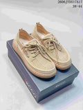 Pair of beige mesh lace-up shoes displayed on a branded box