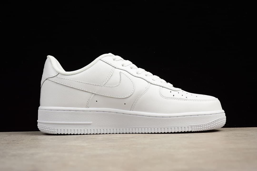 Side profile of the white low-top sneaker against a black background.