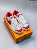 Pair of white and red Nike Blazer Low '77 Jumbo sneakers on an orange shoebox