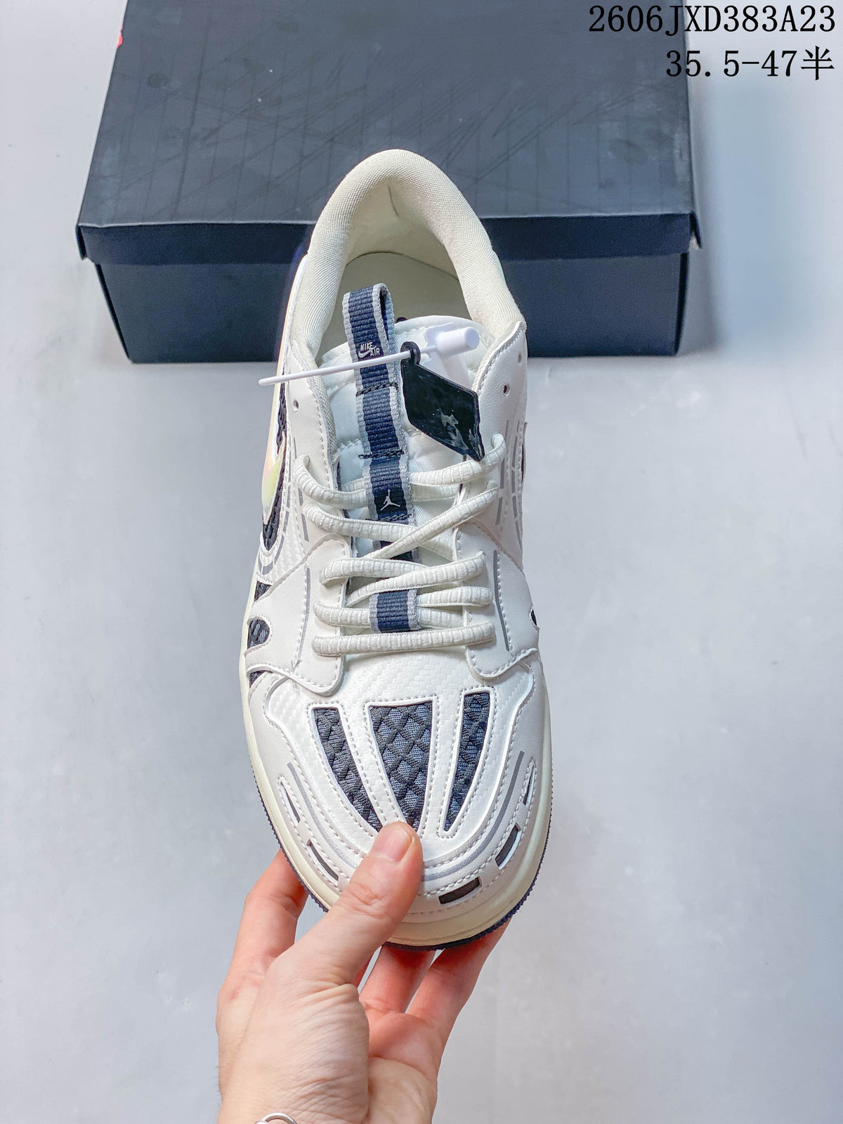 Top view of the sneaker showing laces, tongue, and patterned toe panels