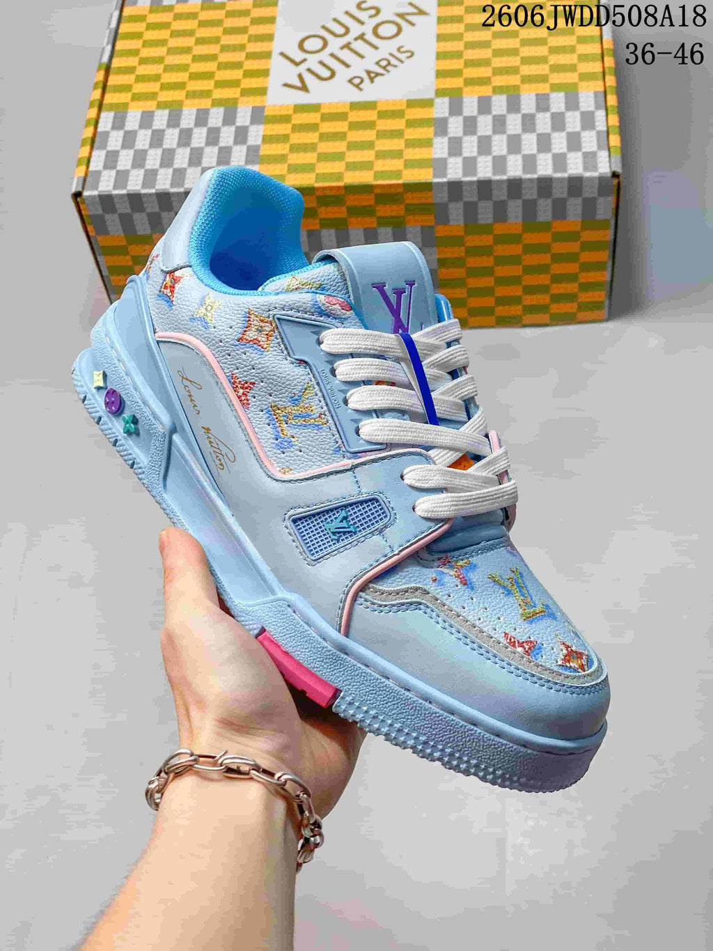 Angled view of the blue sneaker with patterned panels and layered outsole