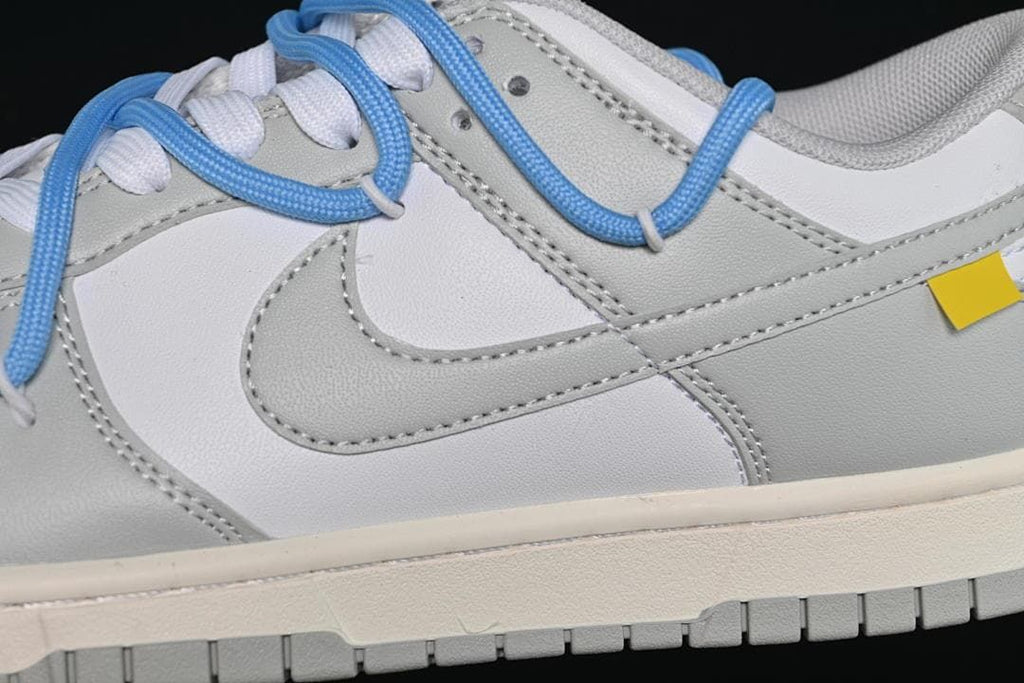 Close-up of the grey side panel, white Swoosh, and blue overlay laces