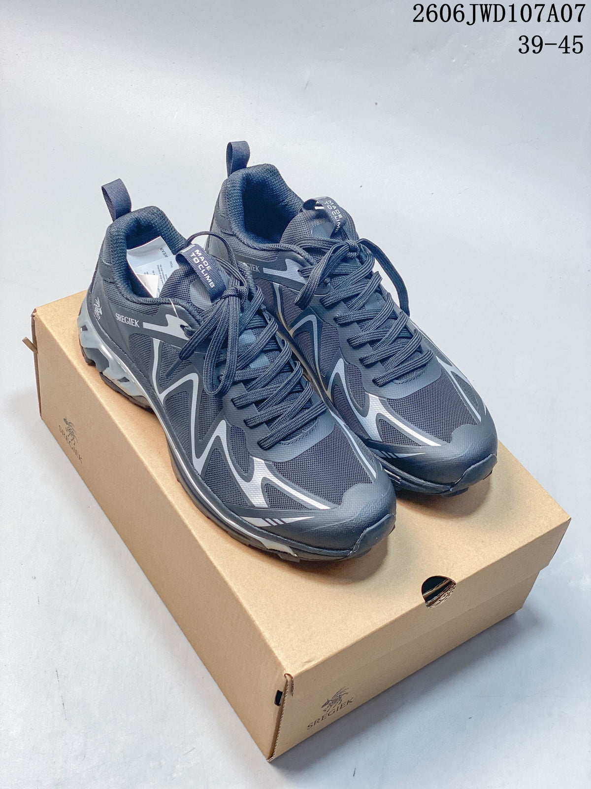 Pair of charcoal and silver Sregiek low-top hiking shoes on a shoebox