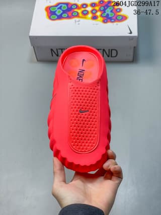 Top view of one red Nike Mind slide showing the textured footbed area and Nike branding.