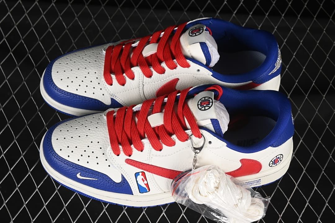 Pair of white, red, and blue low-top sneakers with red laces and an extra set of white laces