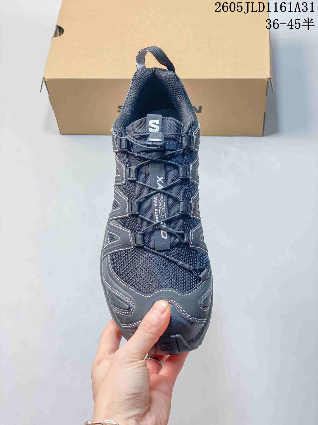 Front view of a dark gray Salomon XA Pro 3D sneaker showing its cord-lacing system.