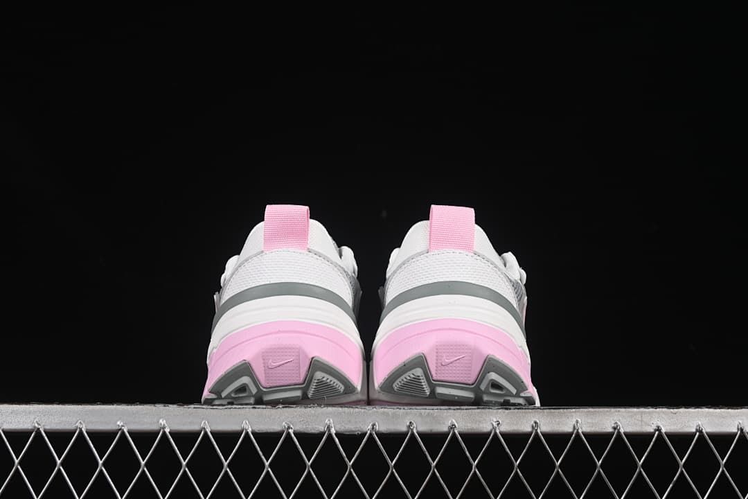 Rear view of the pair highlighting pink heel panels and gray outsole details